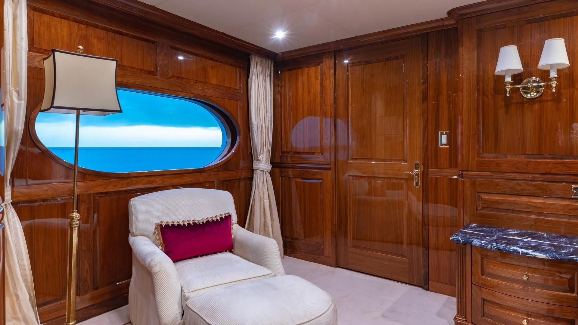 a room with a bed and a chair aboard AMORE Yacht for Charter