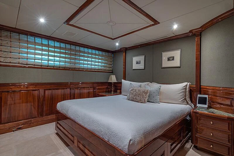 a bed with a white sheet aboard AMORE Yacht for Charter