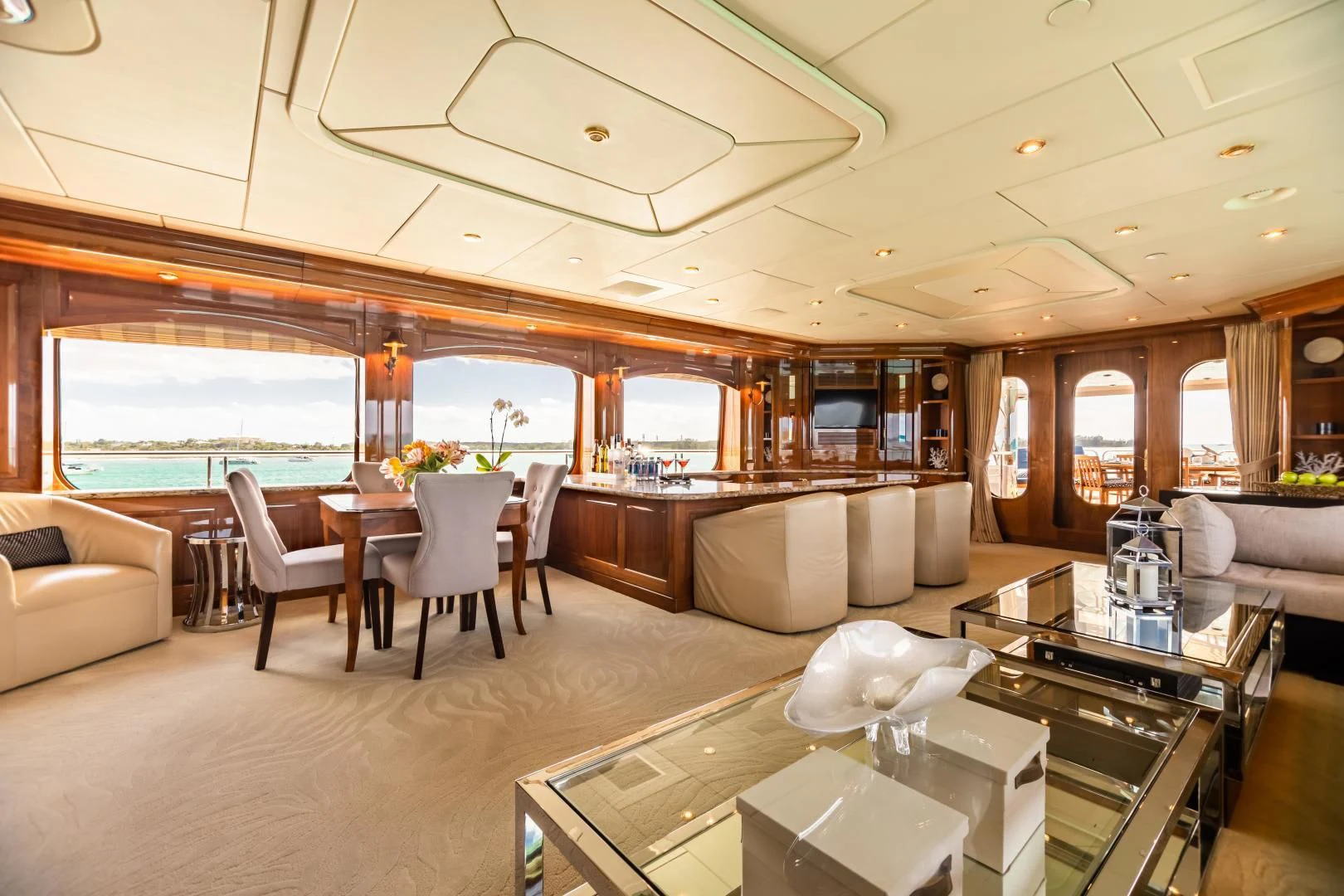 a large living room with a large window aboard AMORE Yacht for Charter