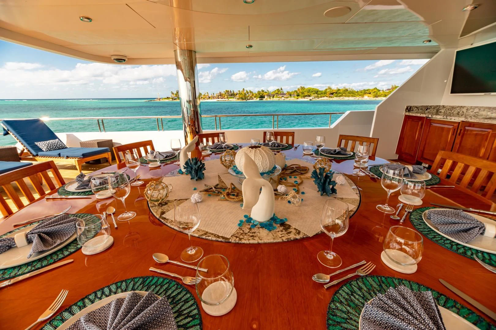 a table set for a dinner party aboard AMORE Yacht for Charter