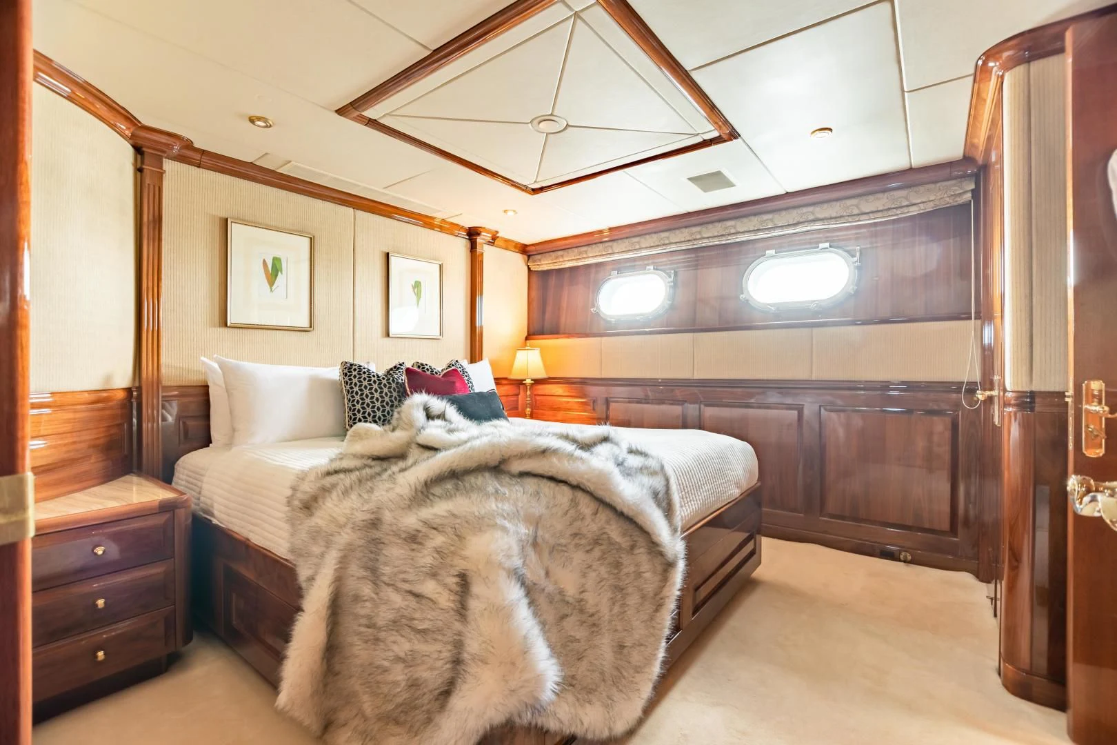 a room with a bed and a wood cabinet aboard AMORE Yacht for Charter