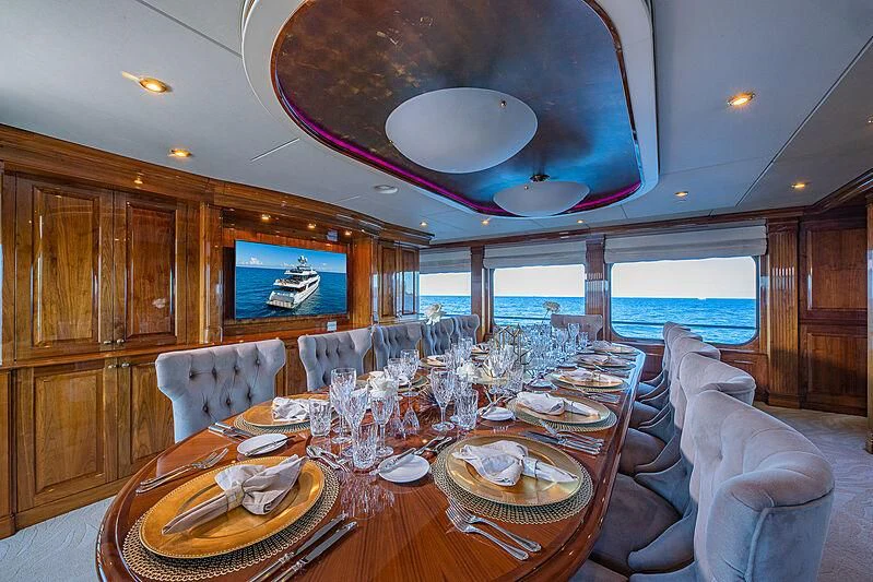 a dining room with a table set for a dinner aboard AMORE Yacht for Charter