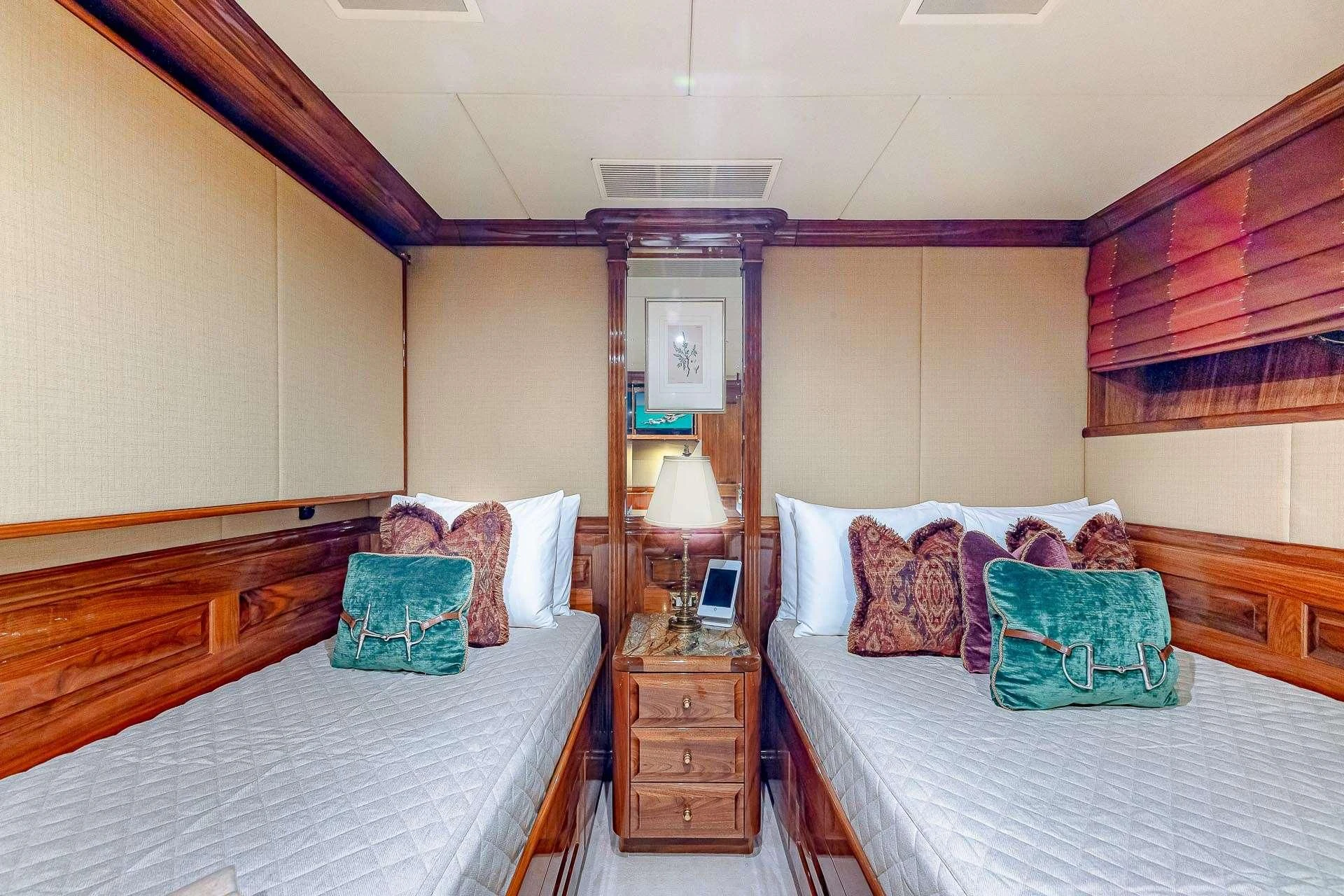 a bedroom with two beds aboard AMORE Yacht for Charter