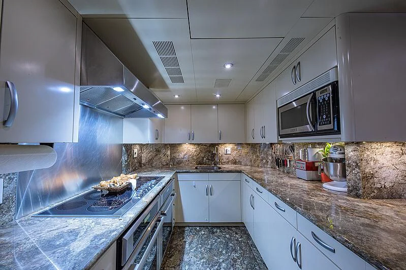 a kitchen with white cabinets aboard AMORE Yacht for Charter