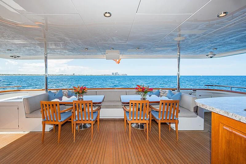 a room with tables and chairs aboard AMORE Yacht for Charter