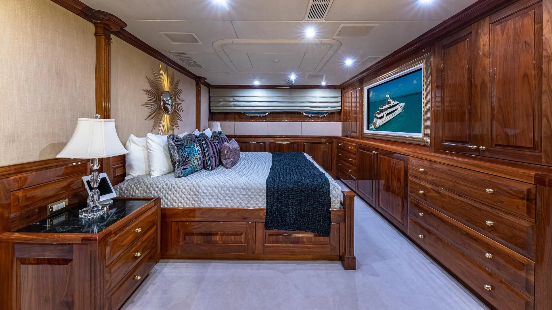 a bedroom with a bed and a tv aboard AMORE Yacht for Charter