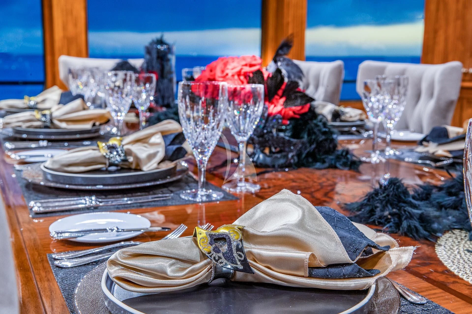 a table with plates and glasses aboard AMORE Yacht for Charter