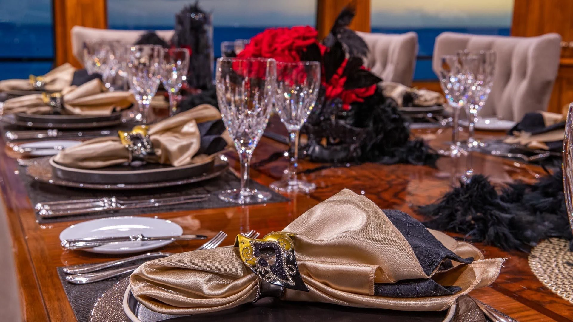 a table with plates and glasses aboard AMORE Yacht for Charter
