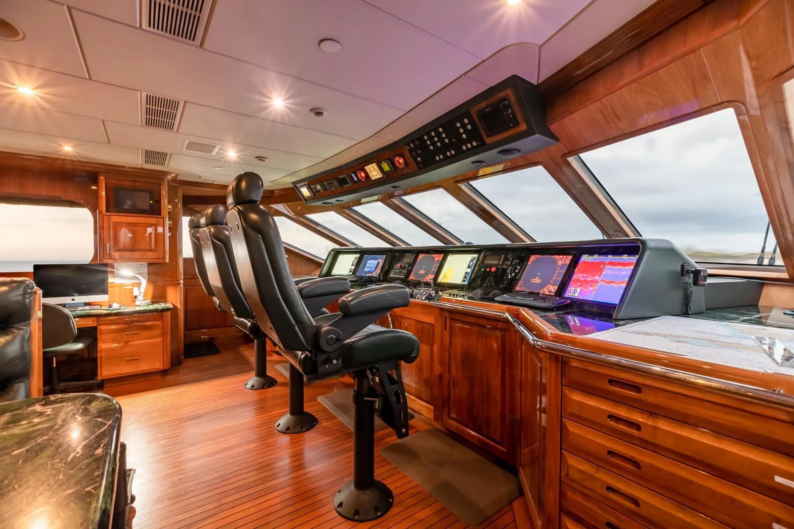 a room with a desk and chairs aboard AMORE Yacht for Charter