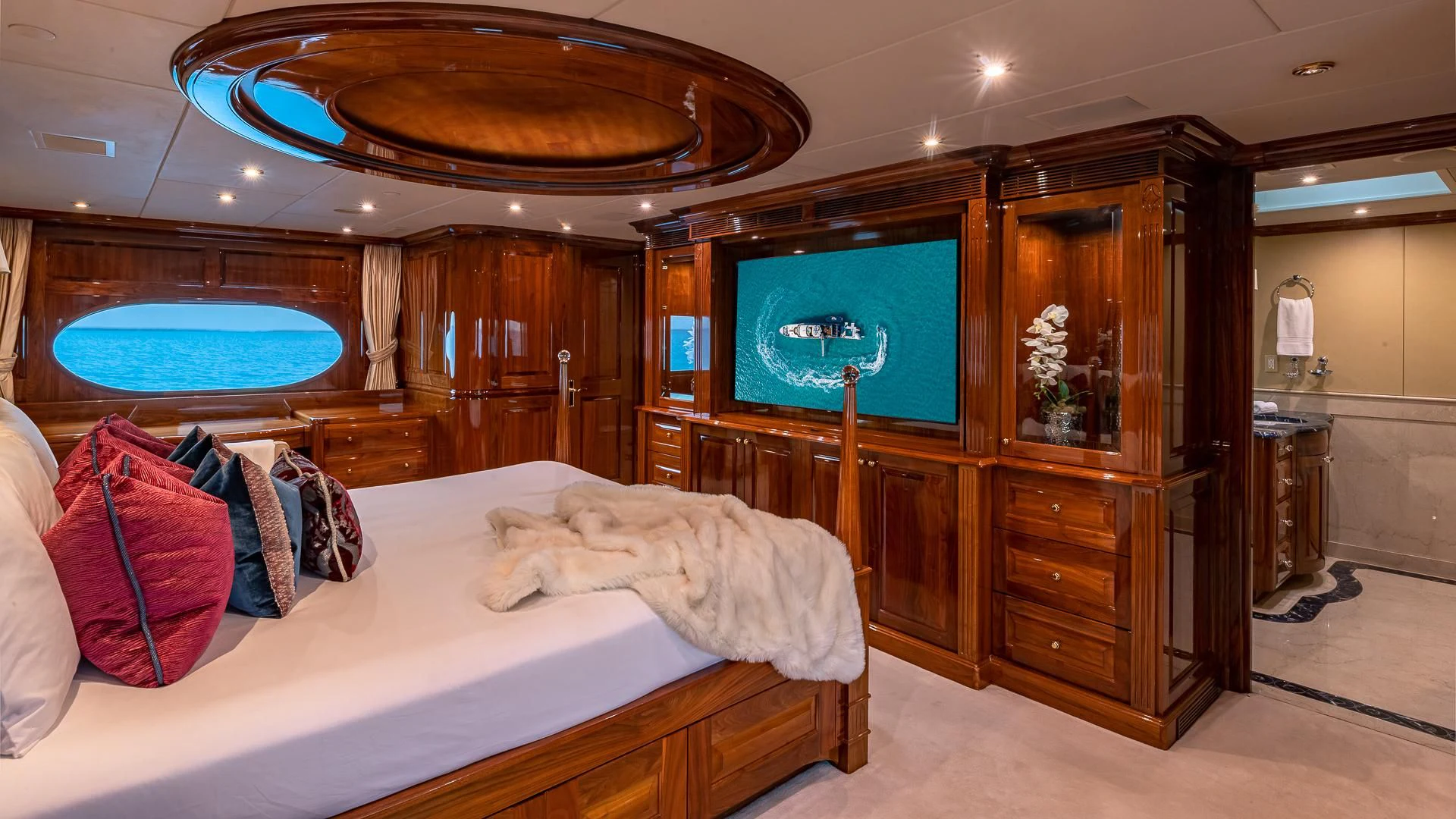 a room with a bed and a tv aboard AMORE Yacht for Charter