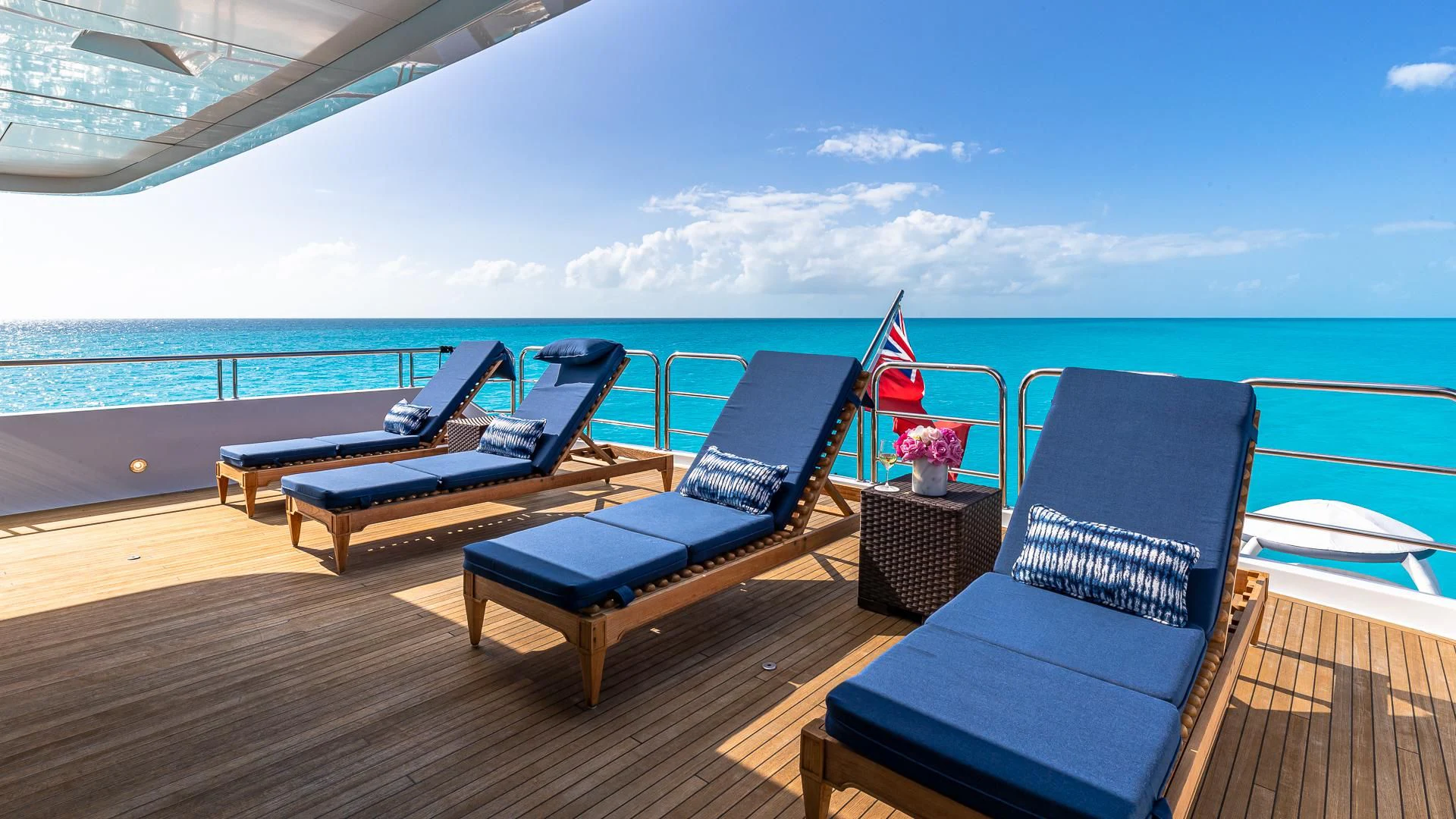 a deck with chairs and a pool aboard AMORE Yacht for Charter