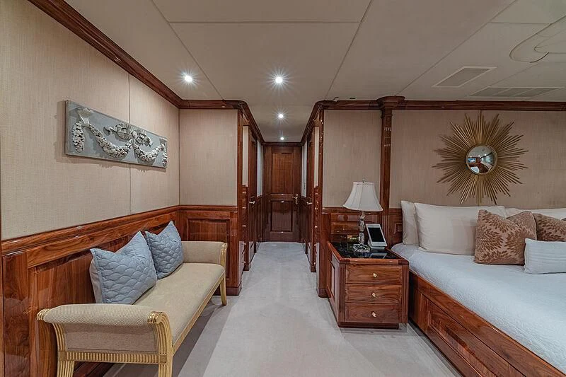 a bedroom with a bed and a chair aboard AMORE Yacht for Charter
