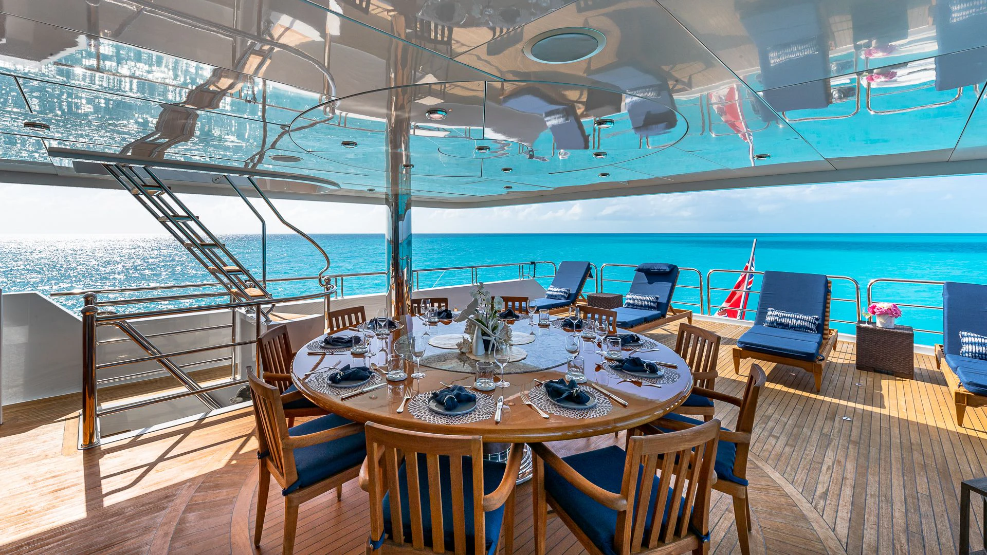 a table with chairs on it aboard AMORE Yacht for Charter
