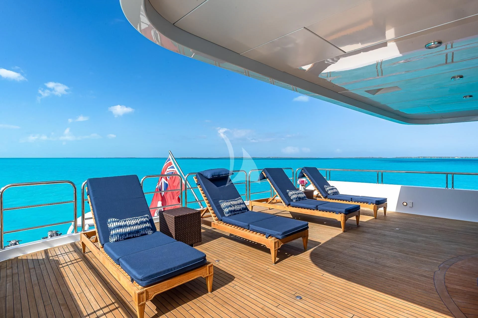 a deck with a pool and a deck with chairs and a pool aboard AMORE Yacht for Charter
