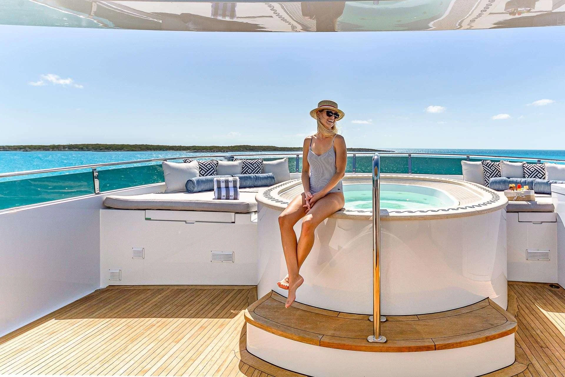 a person sitting on a bathtub aboard AMORE Yacht for Charter