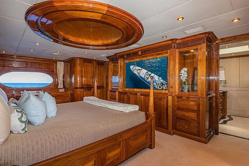 a room with a bed and a mirror aboard AMORE Yacht for Charter
