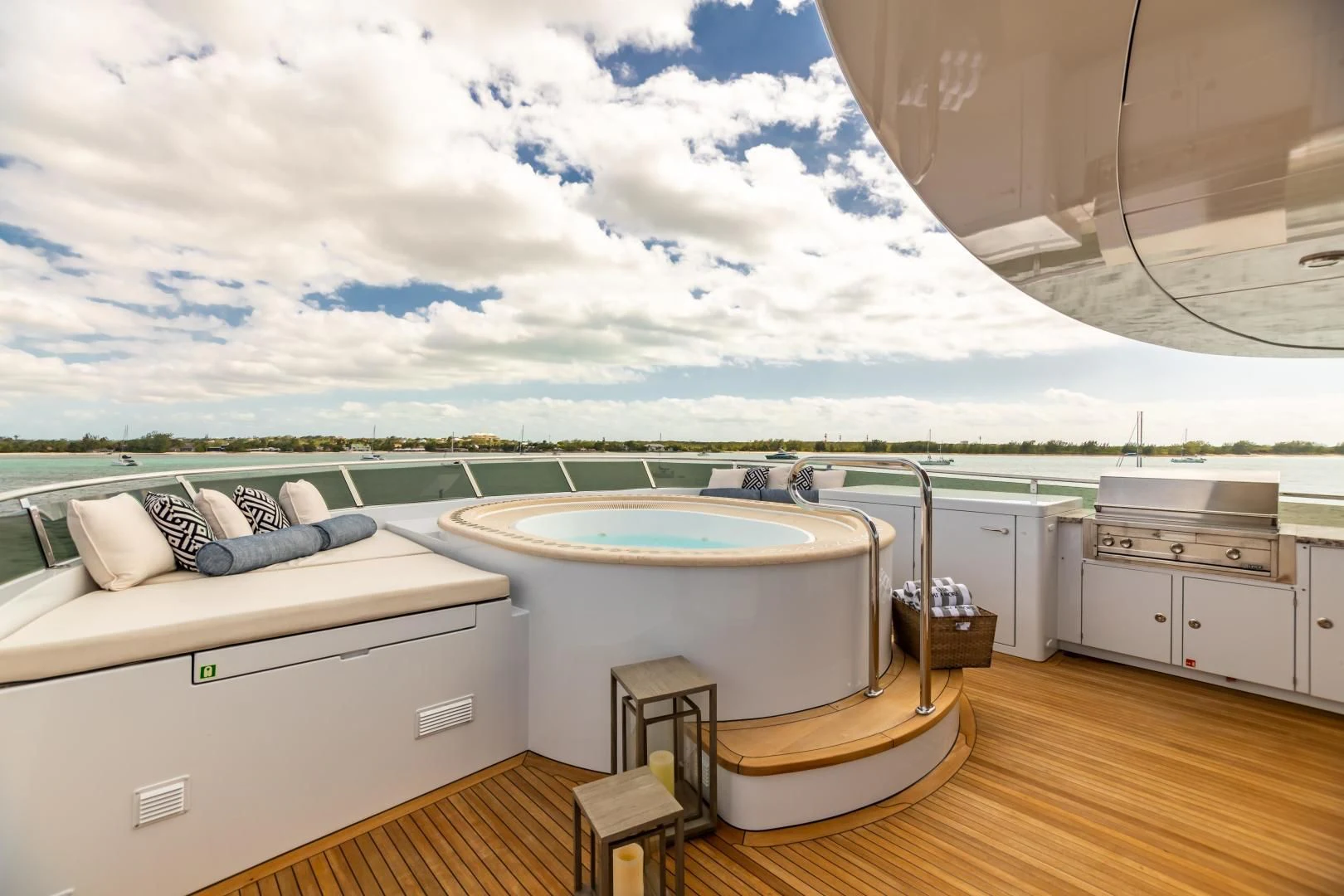 a large white bathtub on a wooden floor next to a white dresser aboard AMORE Yacht for Charter