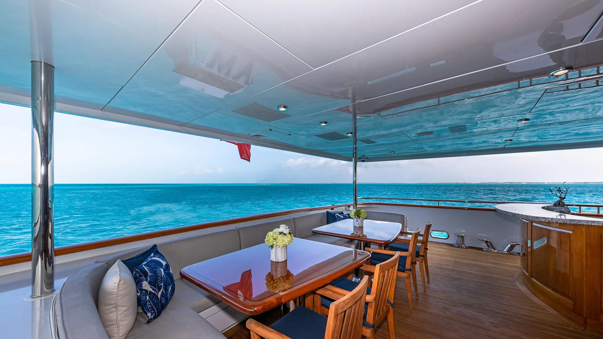 a room with a table and chairs and a view of the ocean aboard AMORE Yacht for Charter