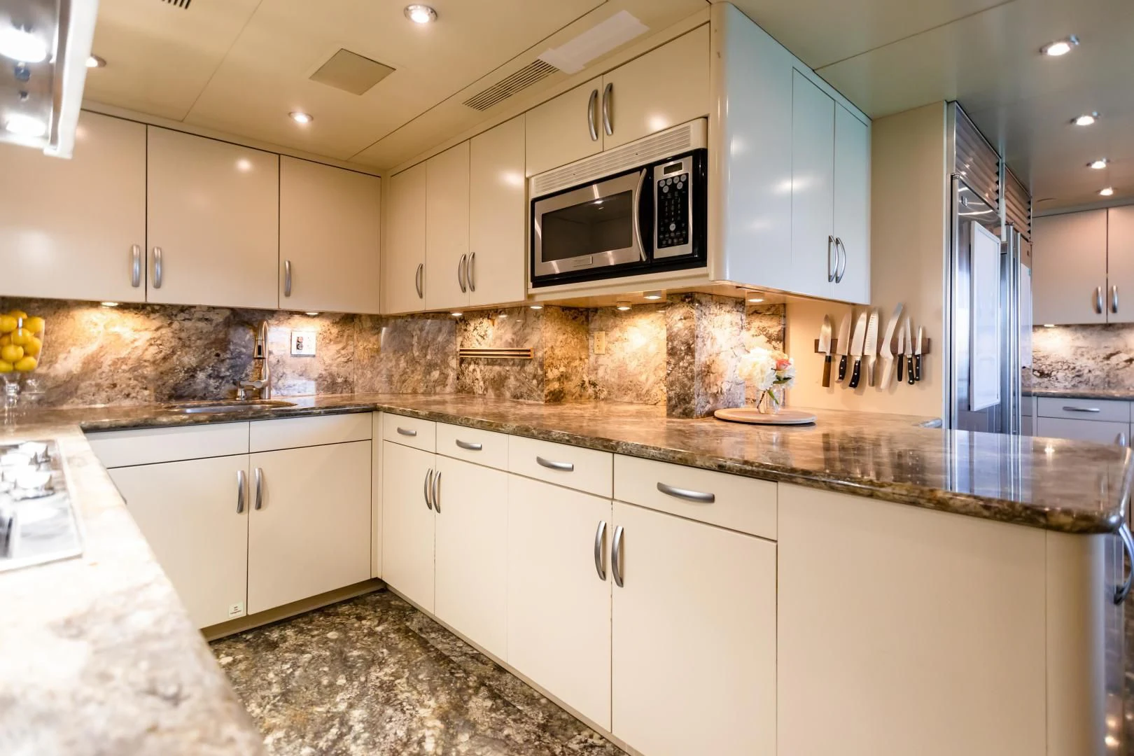 a kitchen with white cabinets aboard AMORE Yacht for Charter