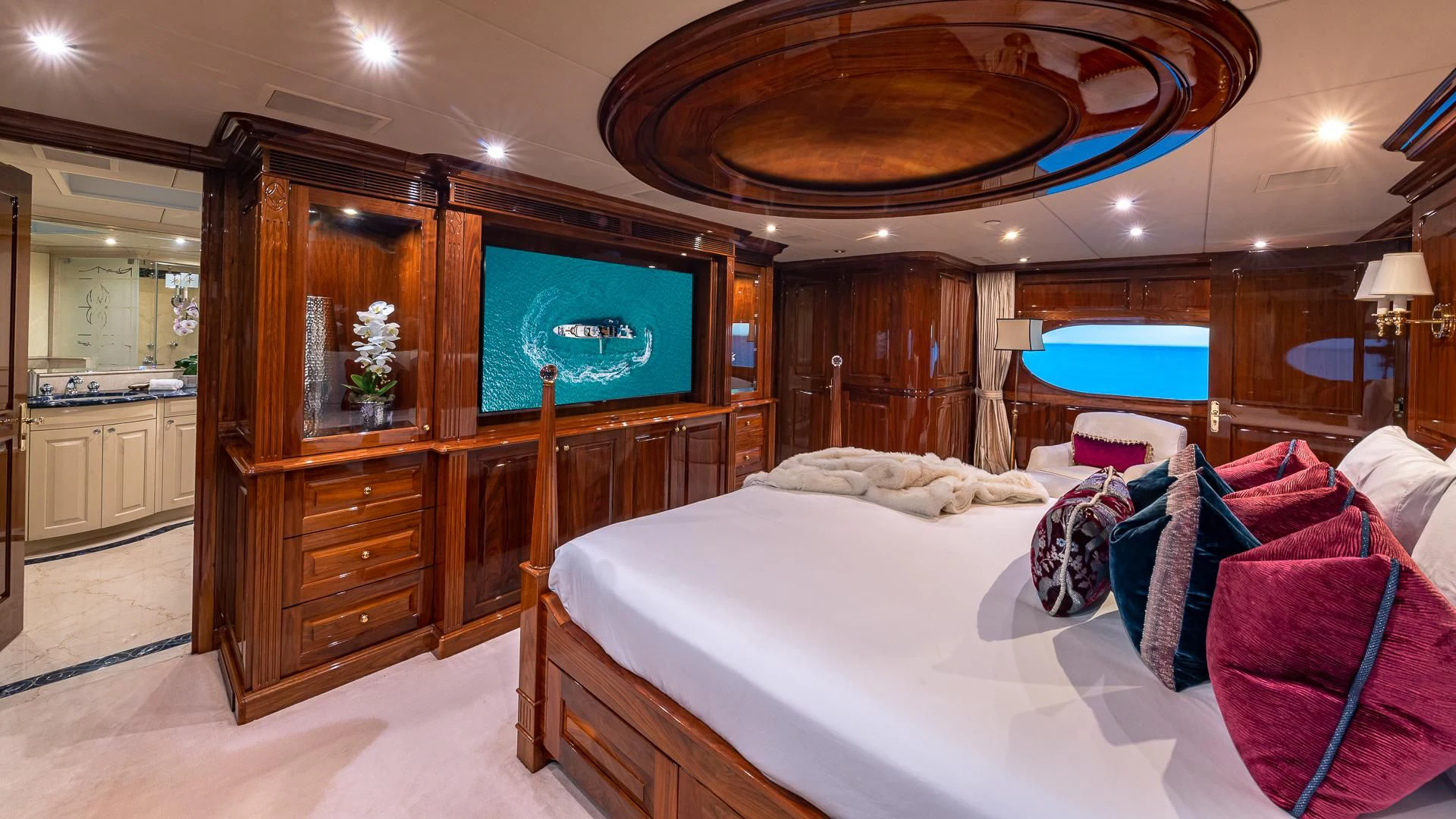 a large bedroom with a large mirror aboard AMORE Yacht for Charter
