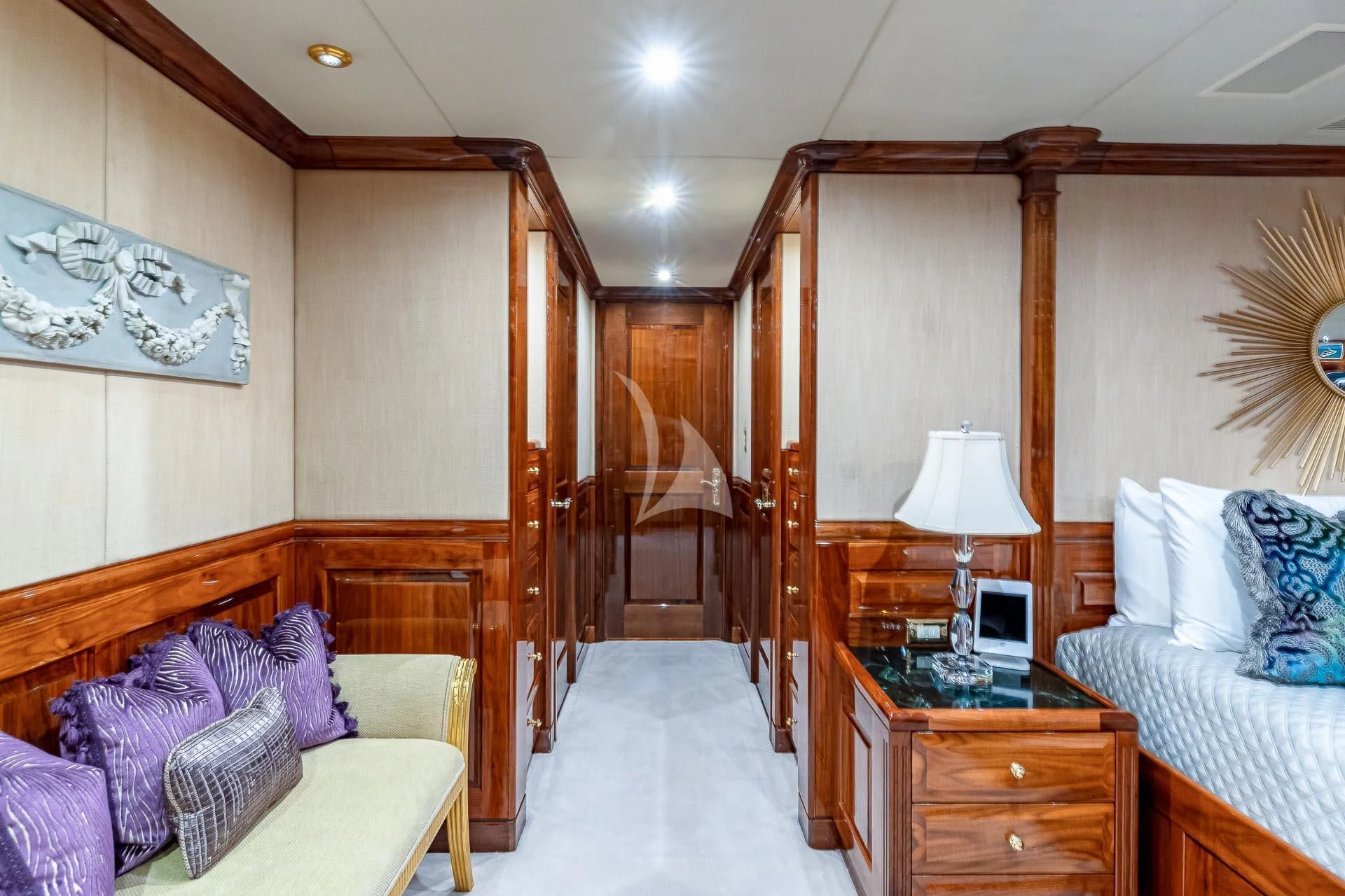 a bedroom with a wood bed and a desk aboard AMORE Yacht for Charter