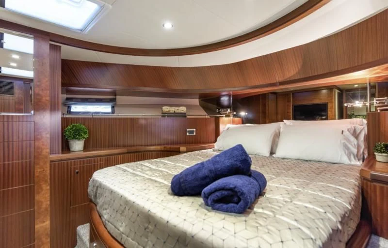 a bed with blue pillows aboard CALYPSO Yacht for Sale