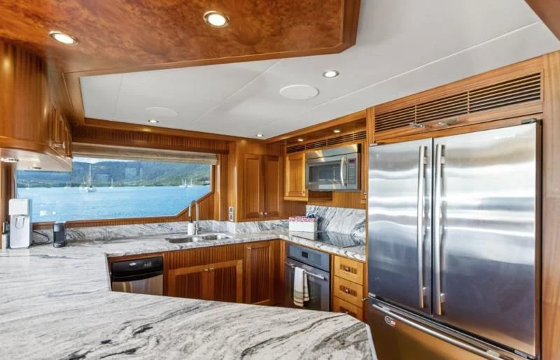 a kitchen with a large refrigerator aboard CALYPSO Yacht for Sale
