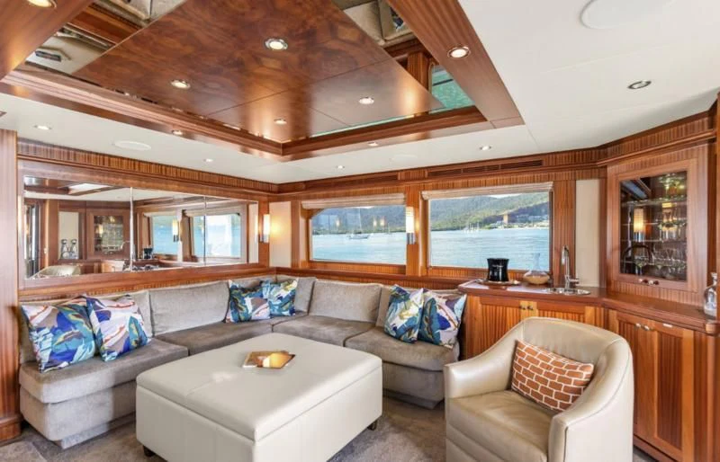 a living room with a couch and a table aboard CALYPSO Yacht for Sale