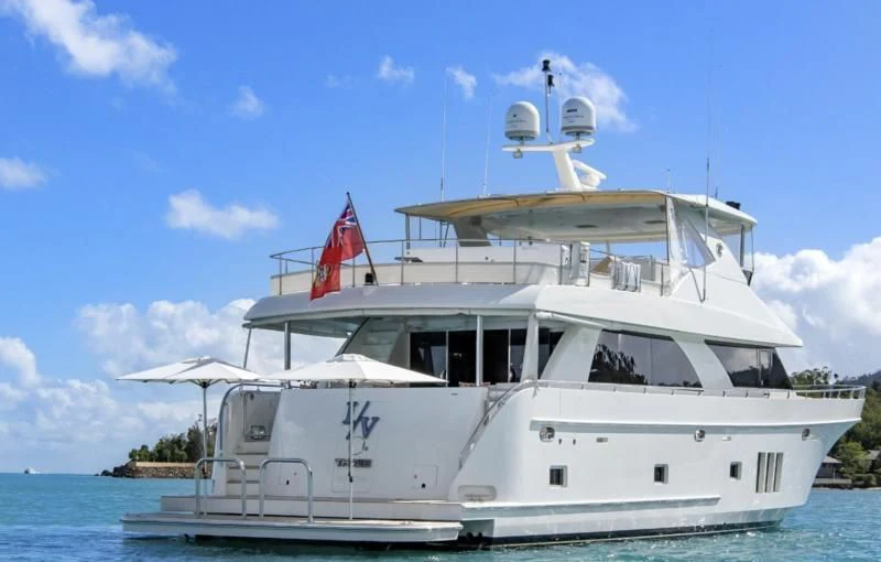a white boat with a flag on it aboard CALYPSO Yacht for Sale