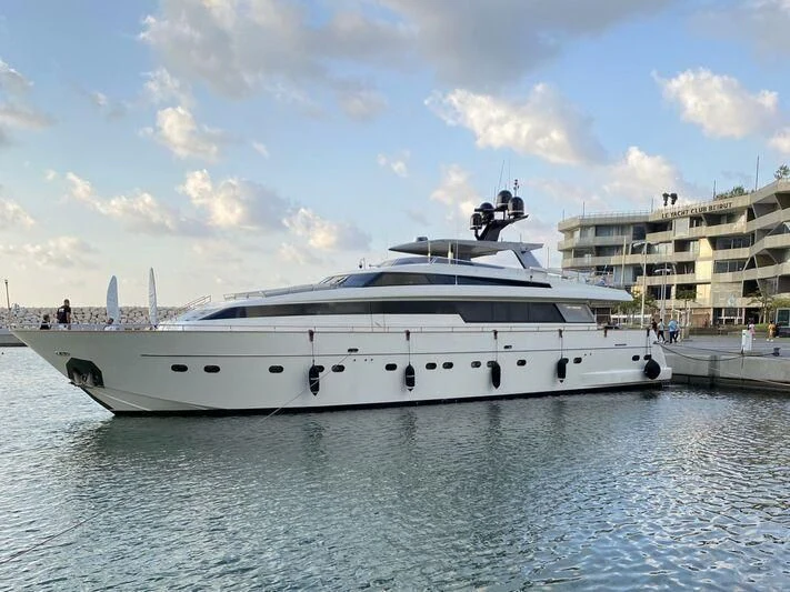 a white yacht docked at a pier aboard D MARE Yacht for Sale