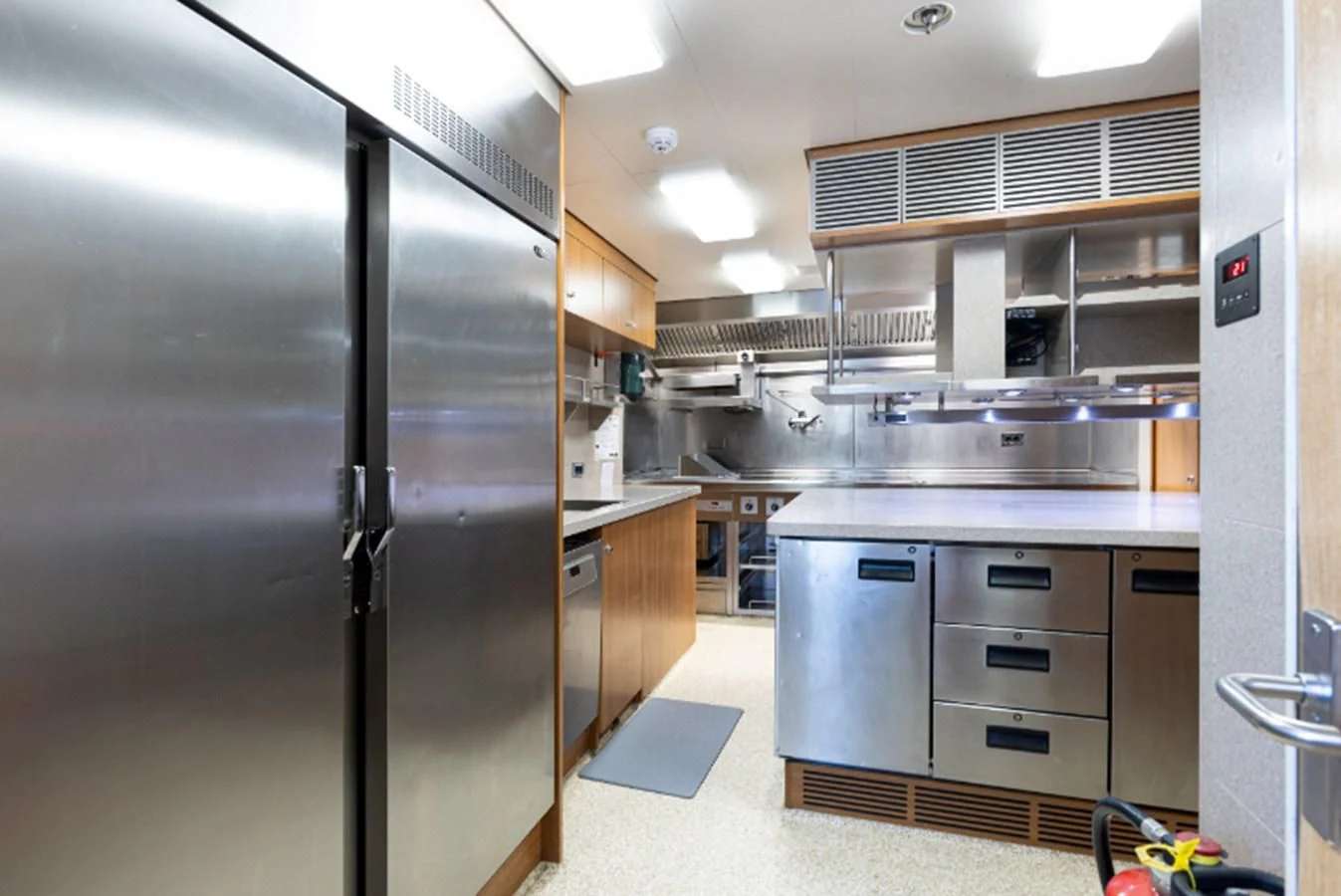 a large kitchen with stainless steel appliances aboard VIBRANCE Yacht for Sale