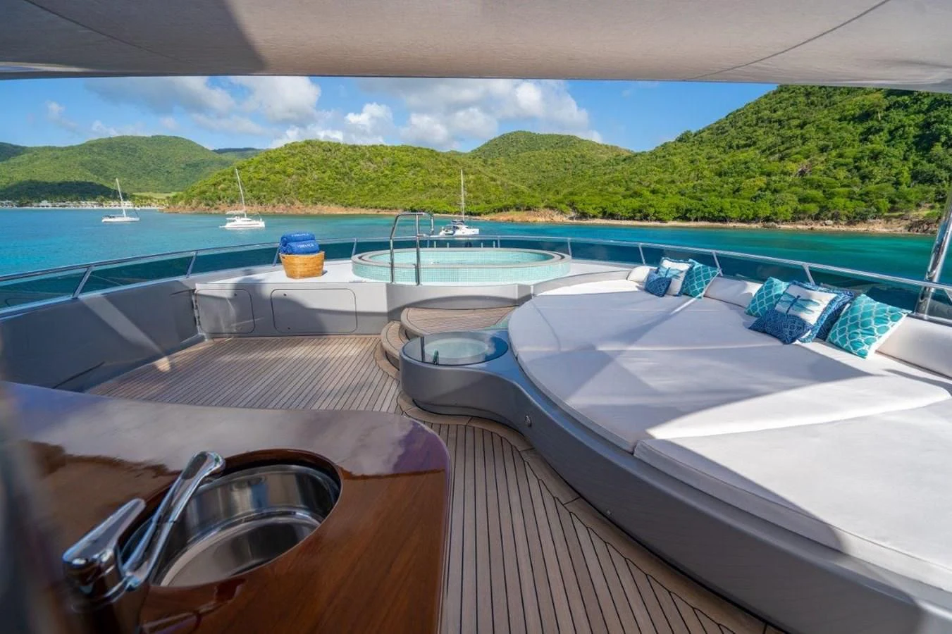 a deck with a view of a bay and boats aboard VIBRANCE Yacht for Sale
