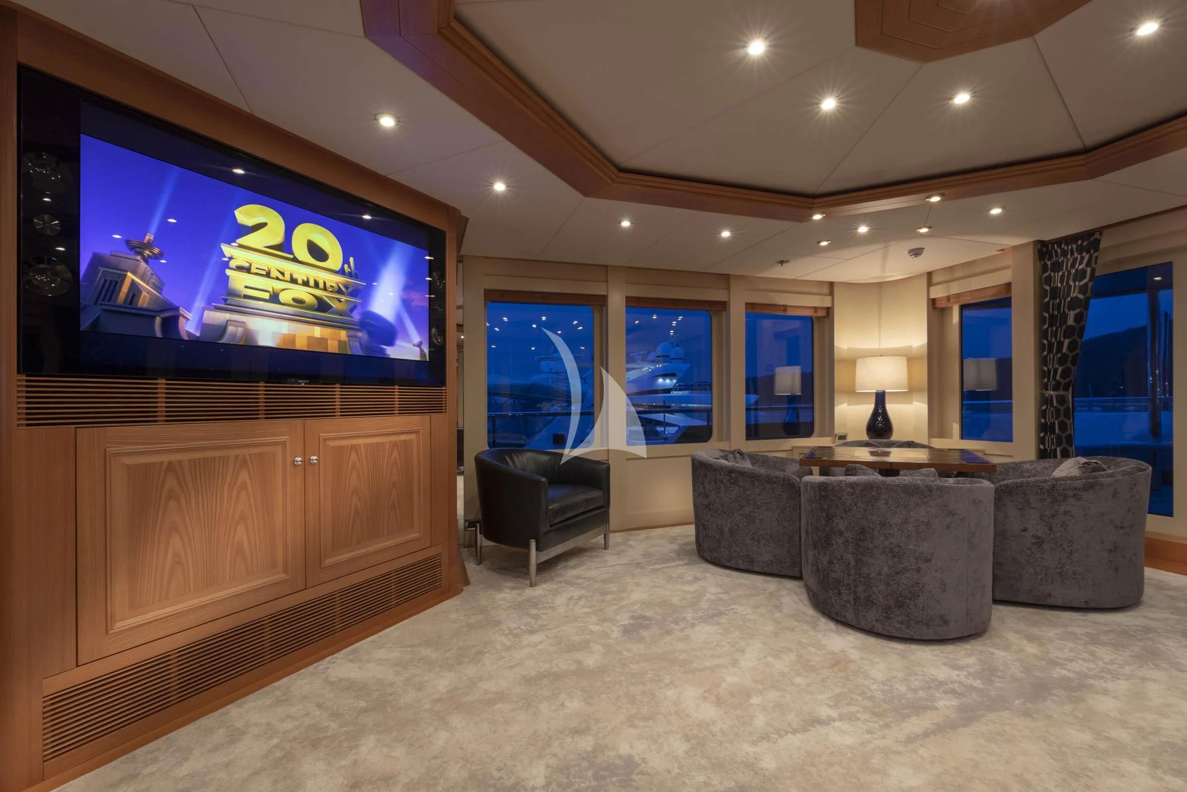 a room with a couch and a tv on the wall aboard VIBRANCE Yacht for Sale