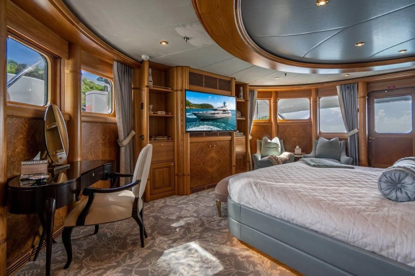 a bedroom with a bed and a television aboard VIBRANCE Yacht for Sale
