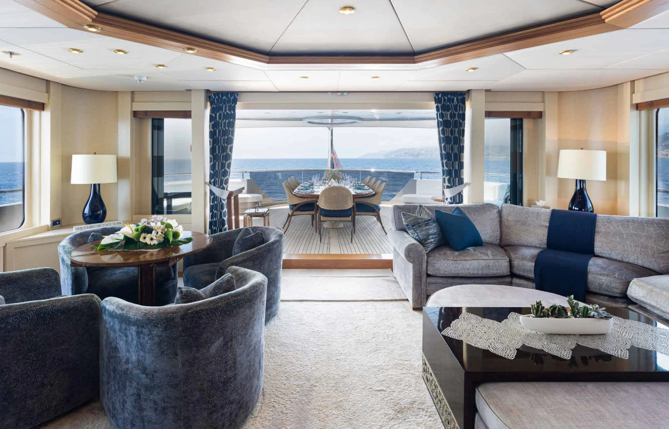 a living room with a large balcony aboard VIBRANCE Yacht for Sale