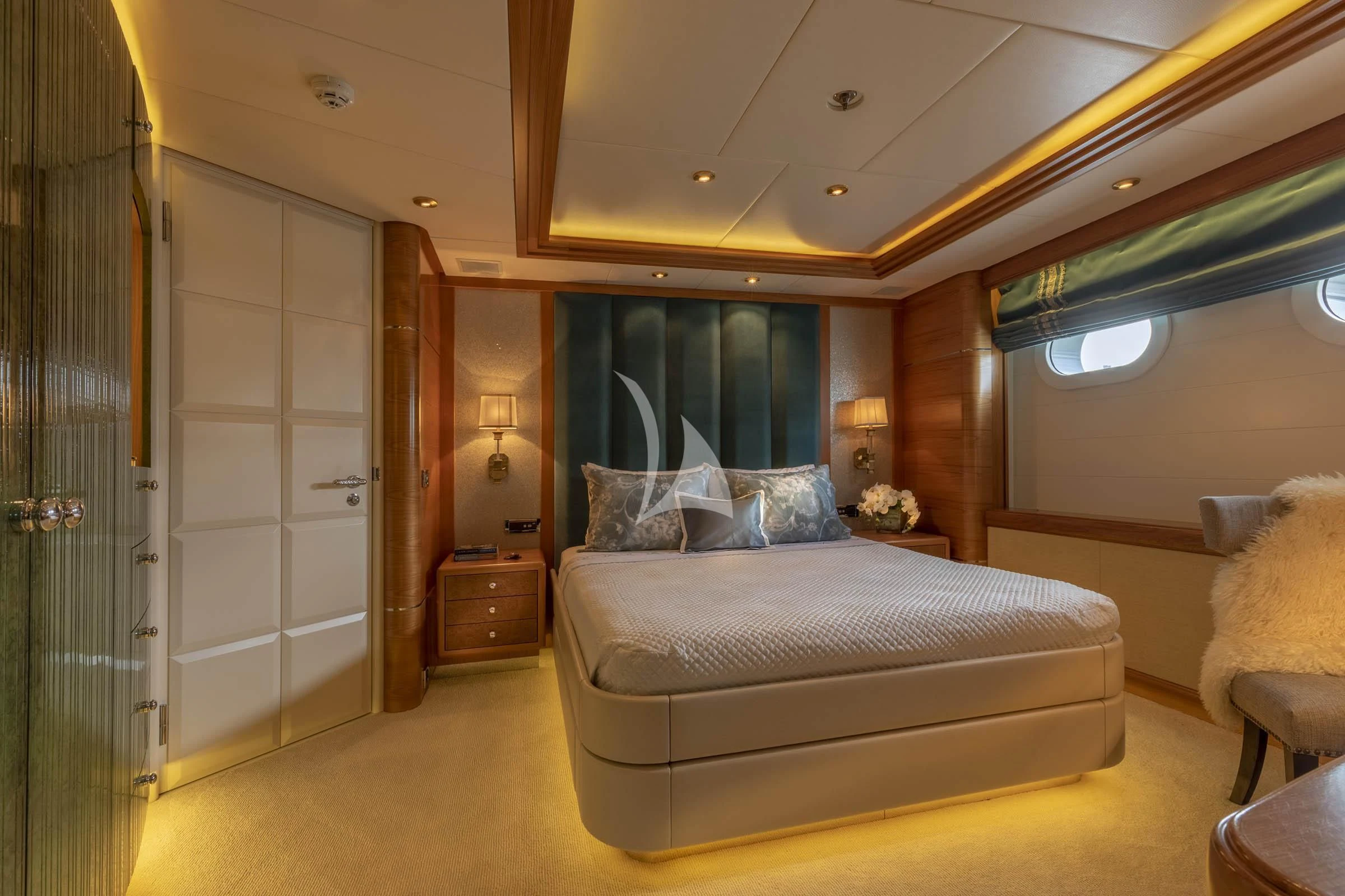 a bedroom with a bed and a door aboard VIBRANCE Yacht for Sale