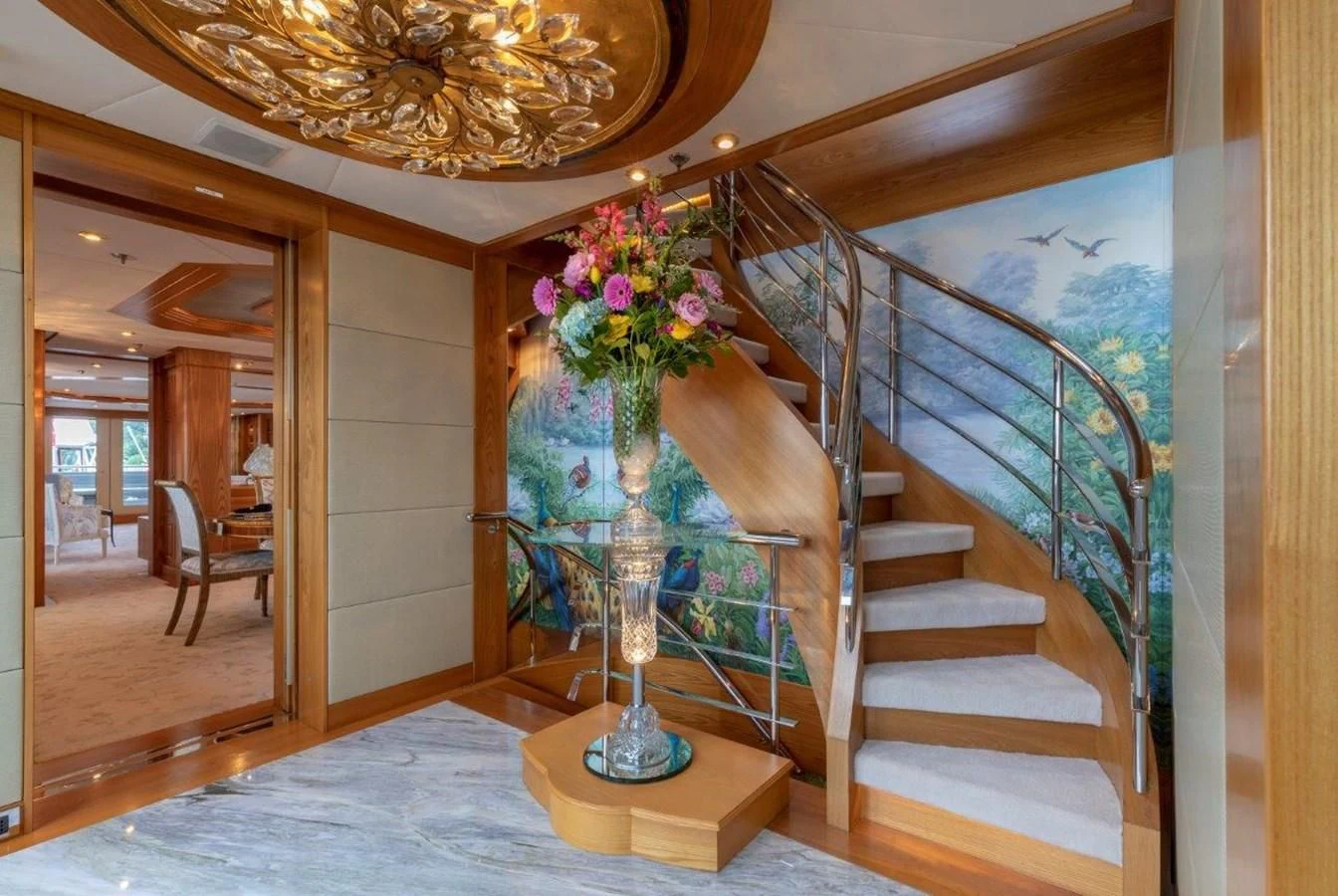a large staircase with a vase of flowers on it aboard VIBRANCE Yacht for Sale