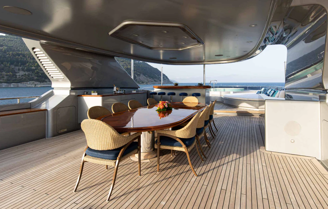 a table and chairs on a boat aboard VIBRANCE Yacht for Sale
