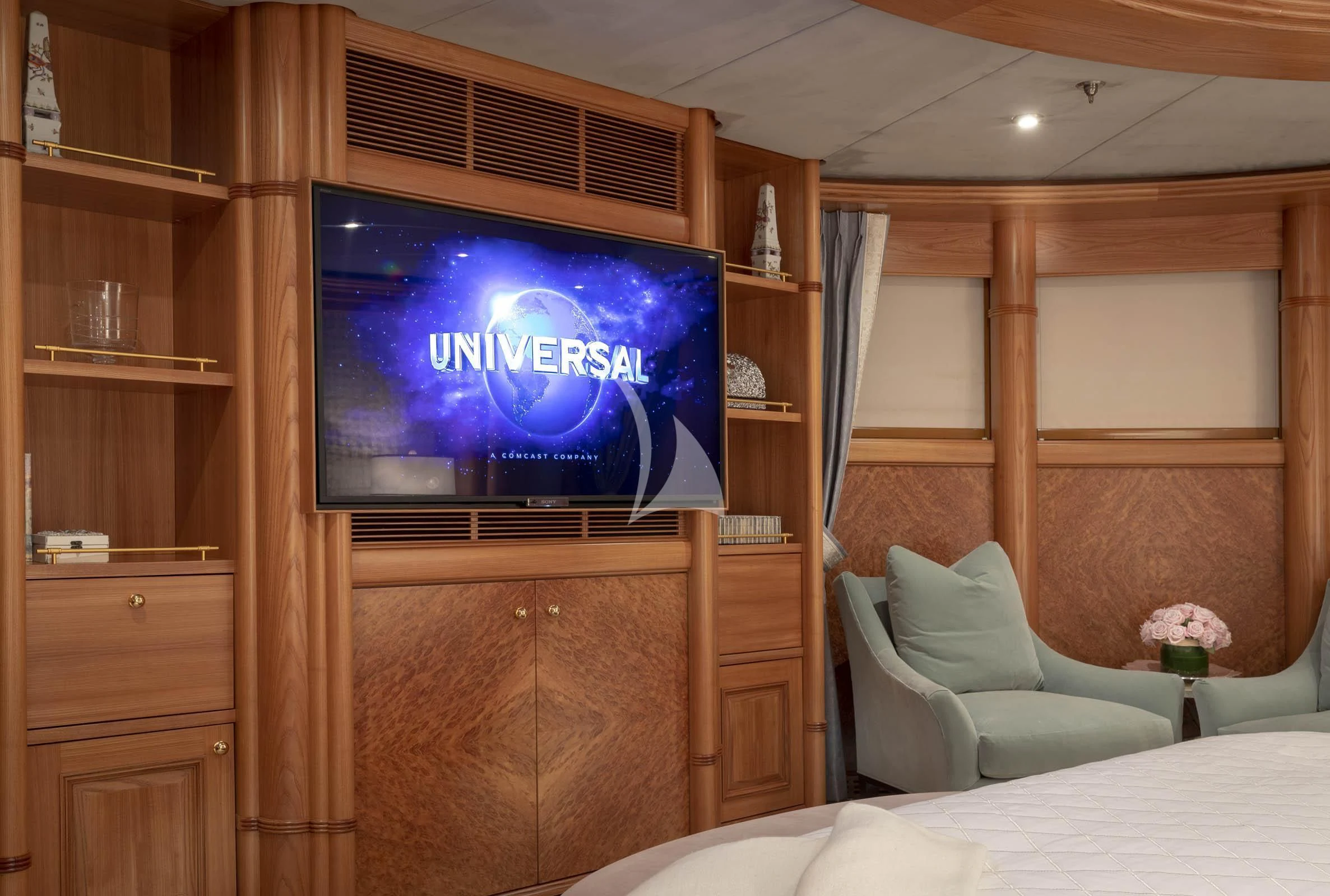 a tv on a stand in a room with a bed and a shelf aboard VIBRANCE Yacht for Sale