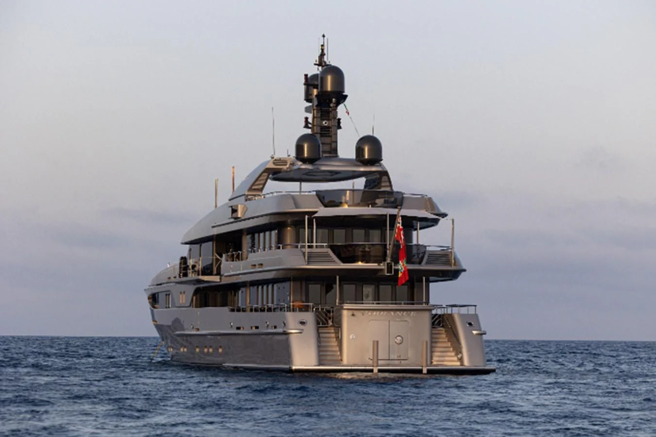 a large ship in the water with Thomas Point Shoal Light in the background aboard VIBRANCE Yacht for Sale