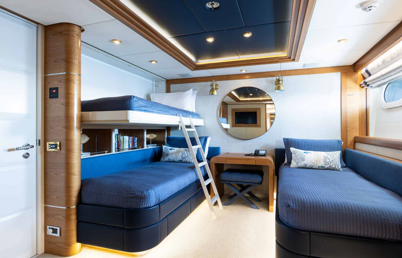 a bedroom with a bed and a mirror aboard VIBRANCE Yacht for Sale