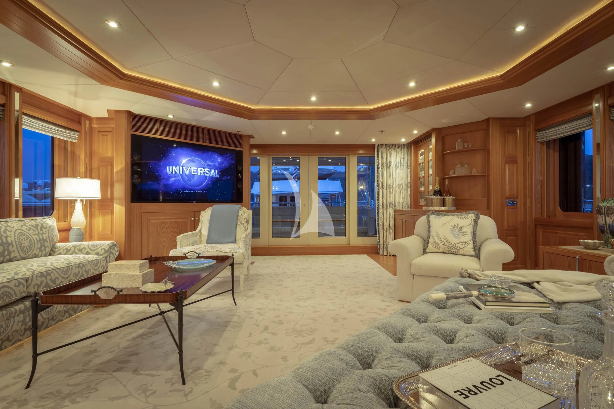 a living room with a large screen aboard VIBRANCE Yacht for Sale