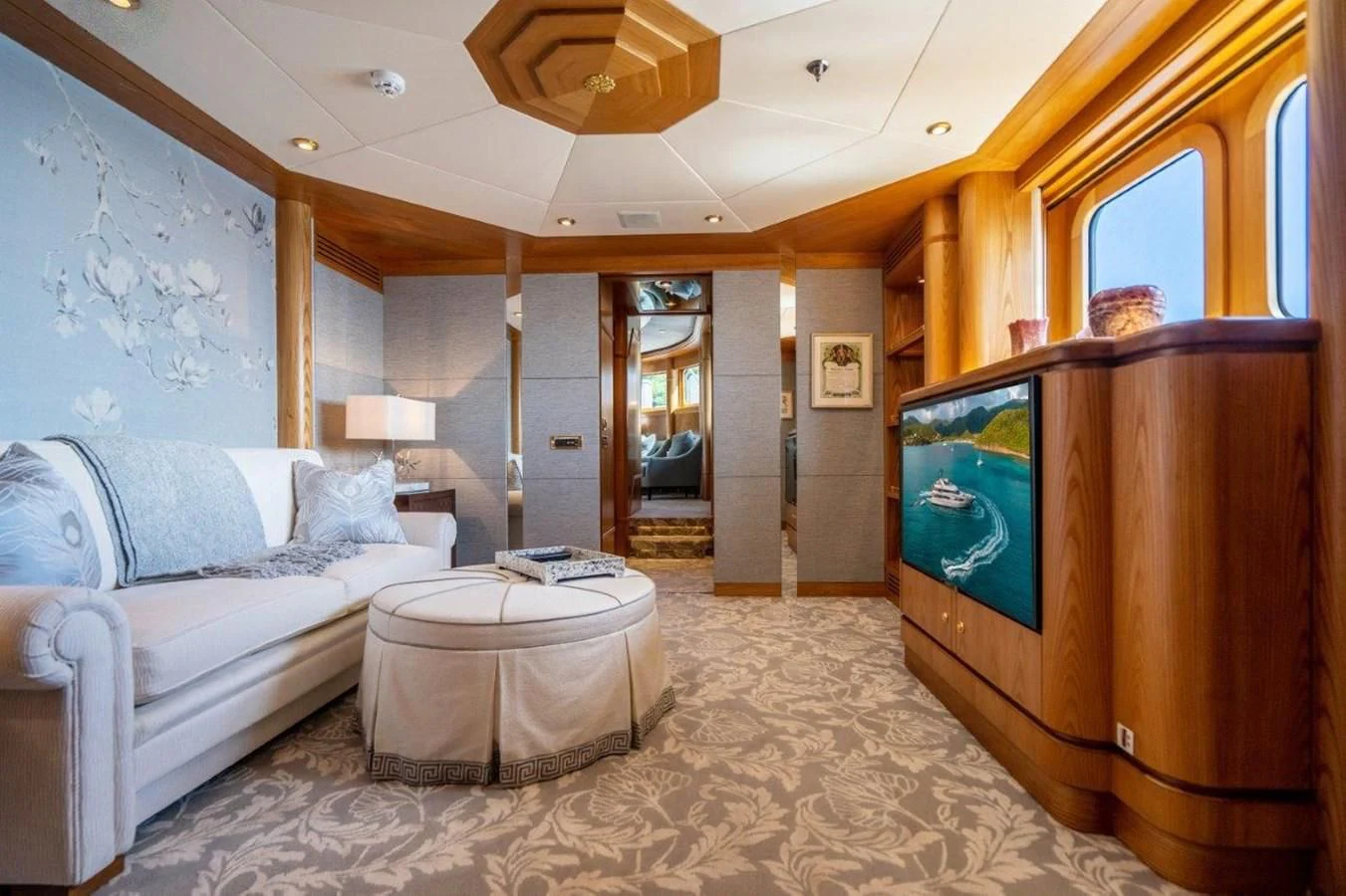 a large room with a couch and a tv aboard VIBRANCE Yacht for Sale