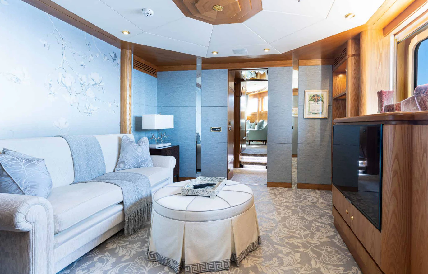 a living room with a couch and a television aboard VIBRANCE Yacht for Sale