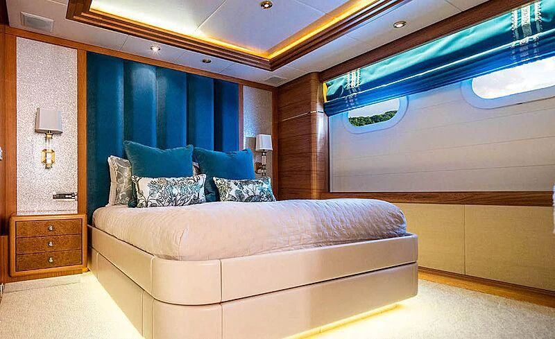 a room with a bed and a couch aboard VIBRANCE Yacht for Sale