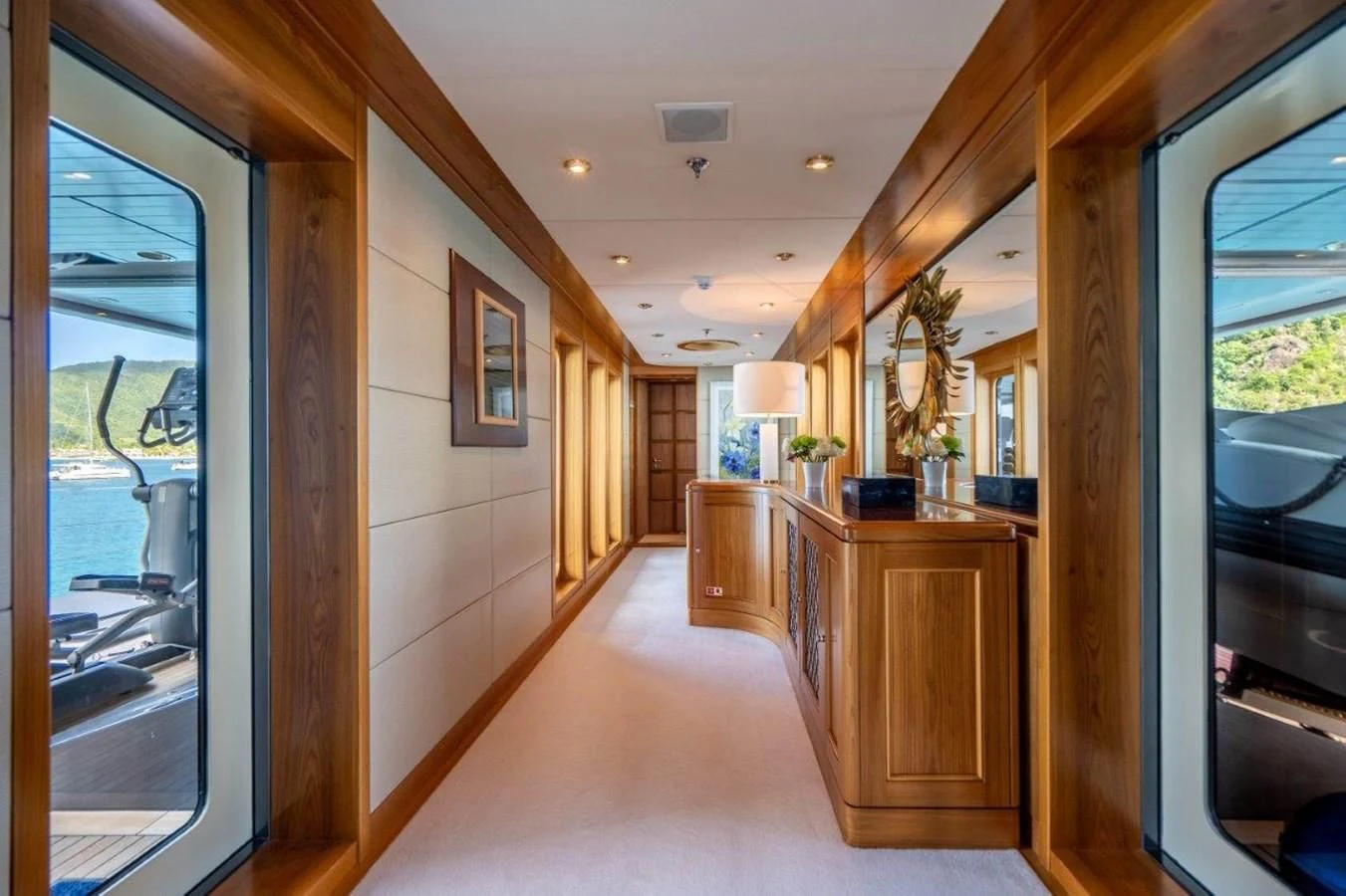 a long hallway with wood cabinets aboard VIBRANCE Yacht for Sale