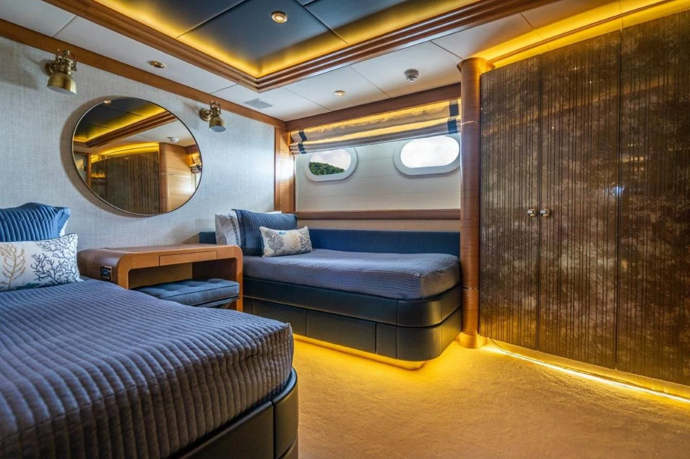 a bedroom with a bed and a mirror aboard VIBRANCE Yacht for Sale