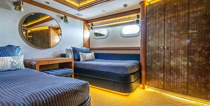 a room with a bed and a mirror aboard VIBRANCE Yacht for Sale