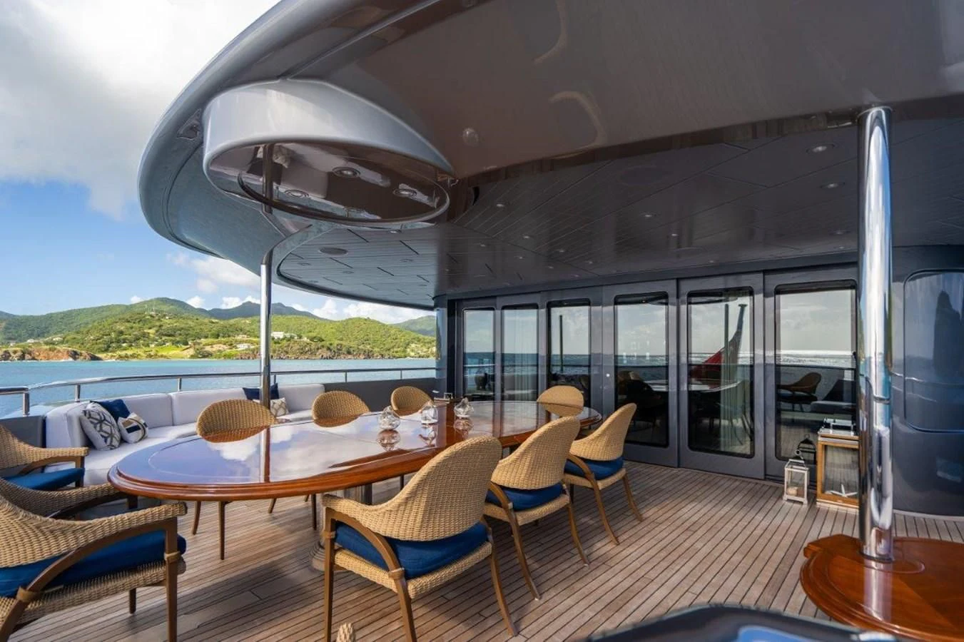 a large patio with a table and chairs aboard VIBRANCE Yacht for Sale