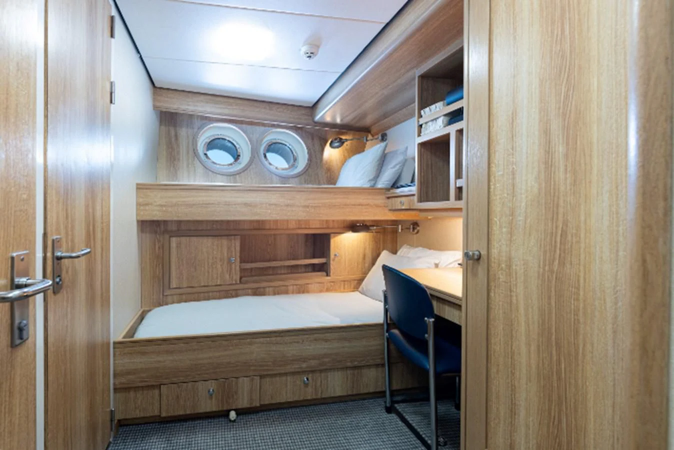 a room with a bed and a desk aboard VIBRANCE Yacht for Sale
